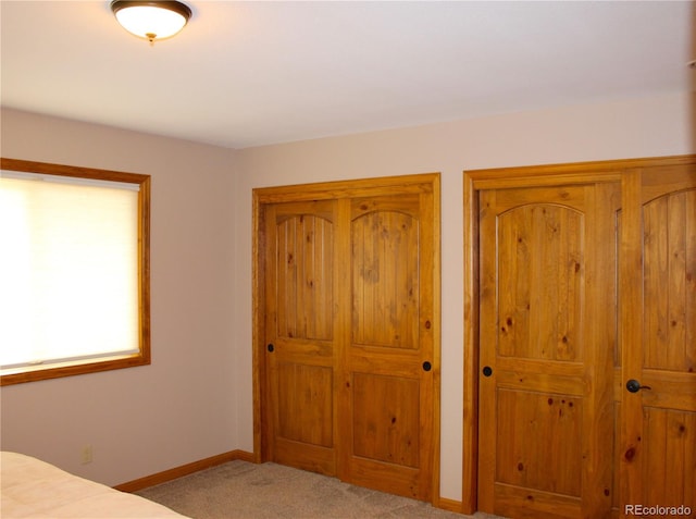 unfurnished bedroom featuring light colored carpet