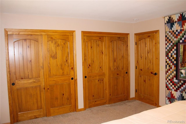 bedroom featuring light carpet