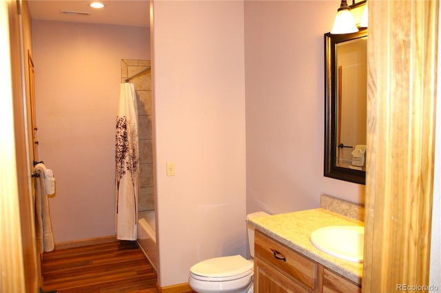 full bathroom featuring vanity, toilet, wood-type flooring, and shower / bath combo with shower curtain