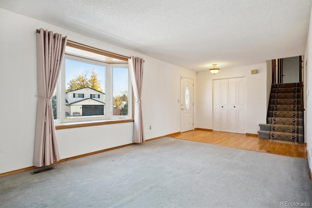 interior space featuring light hardwood / wood-style flooring and a textured ceiling