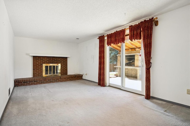 unfurnished living room with carpet flooring, a textured ceiling, and a brick fireplace