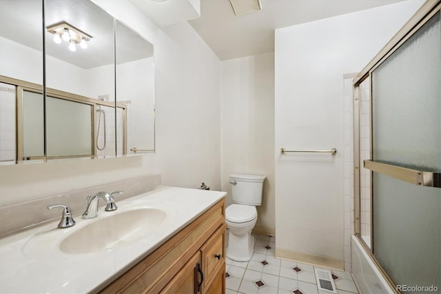 full bathroom with tile patterned floors, vanity, toilet, and enclosed tub / shower combo