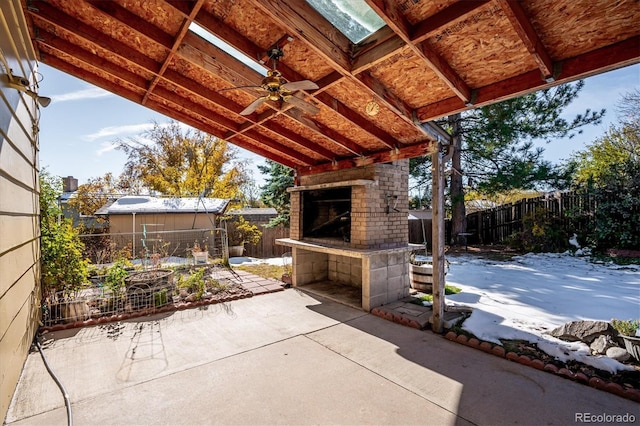 view of patio / terrace with ceiling fan and an outdoor fireplace