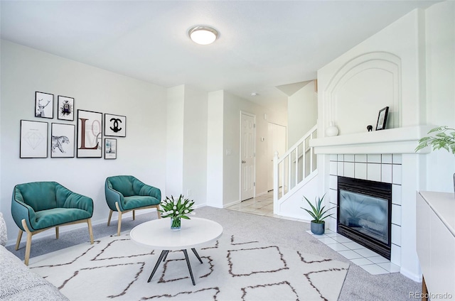 carpeted living room with a tiled fireplace