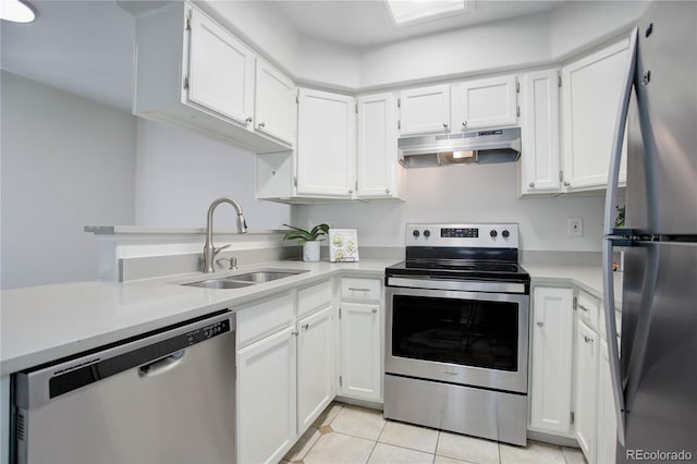 kitchen with white cabinets, light tile patterned floors, stainless steel appliances, and sink