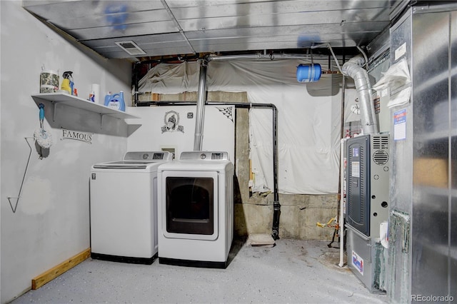 clothes washing area with heating unit and independent washer and dryer