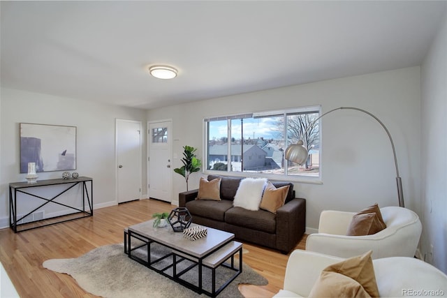 living room with baseboards and wood finished floors