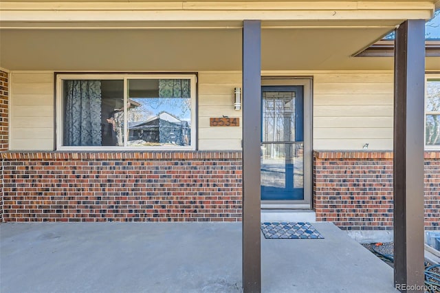 property entrance with brick siding