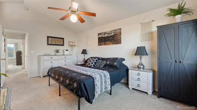 carpeted bedroom featuring vaulted ceiling, a ceiling fan, and baseboards