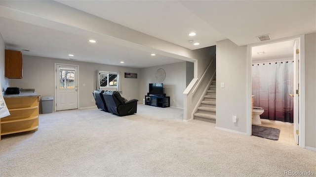 living area featuring visible vents, baseboards, recessed lighting, stairs, and light colored carpet