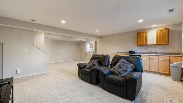 living area featuring recessed lighting, visible vents, baseboards, and light colored carpet