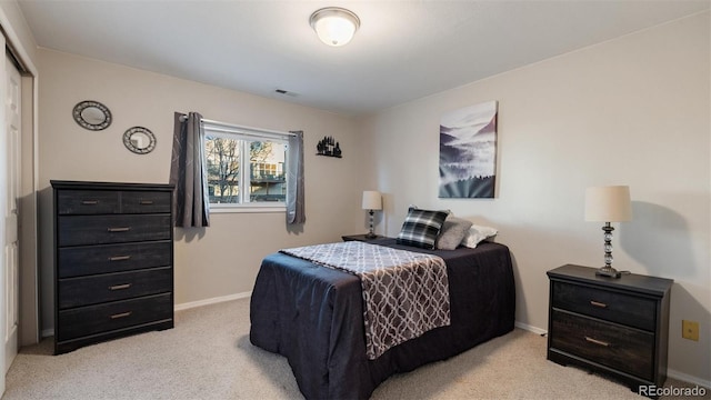 bedroom with light colored carpet, visible vents, and baseboards