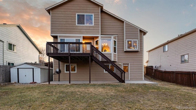 rear view of property with an outbuilding, a lawn, a patio, a shed, and stairs