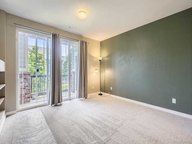 2133 Krisron Rd Unit A202, Fort Collins, CO 80525 - carpeted empty room with baseboards and a textured wall