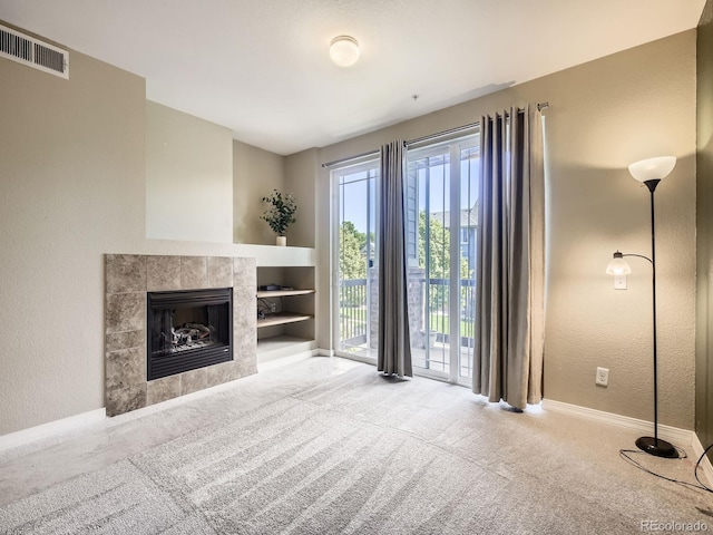 2133 Krisron Rd Unit A202, Fort Collins, CO 80525 - unfurnished living room with carpet floors, a fireplace, a textured wall, and built in features