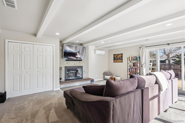 living area featuring visible vents, a wall mounted AC, a brick fireplace, beam ceiling, and carpet