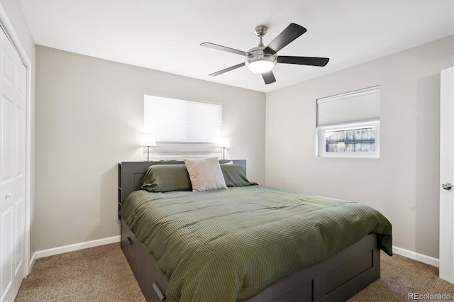 bedroom featuring carpet floors, ceiling fan, baseboards, and a closet