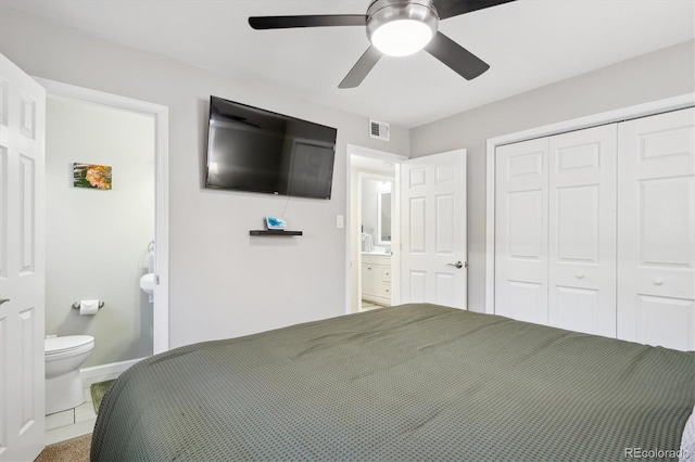 bedroom with visible vents, baseboards, a ceiling fan, ensuite bath, and a closet