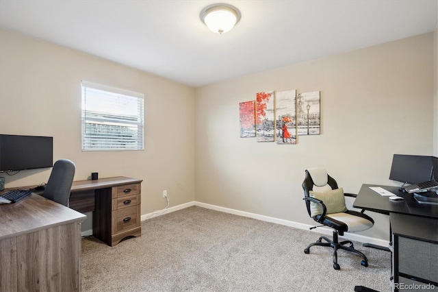 home office featuring baseboards and light colored carpet