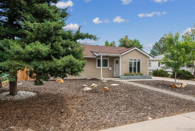 ranch-style house with fence