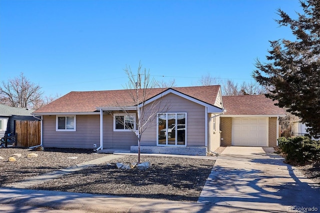 single story home featuring a garage, fence, concrete driveway, and brick siding