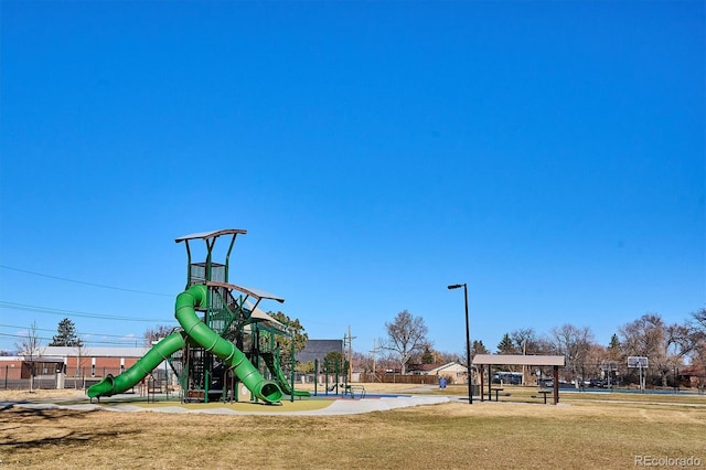 community playground featuring fence and a lawn