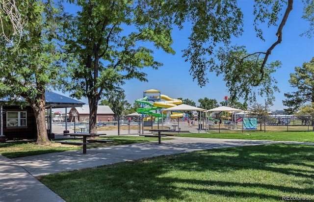 communal playground with a lawn and fence