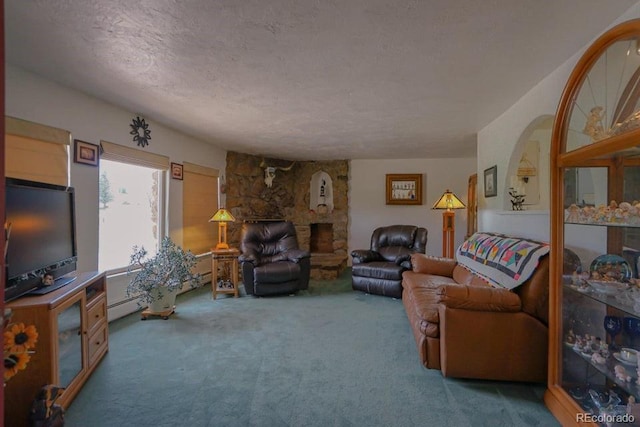 living room with carpet flooring, a stone fireplace, baseboard heating, and a textured ceiling