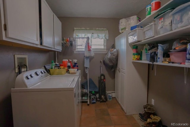 laundry room featuring separate washer and dryer and cabinets