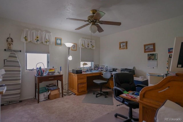 office space with ceiling fan and light carpet