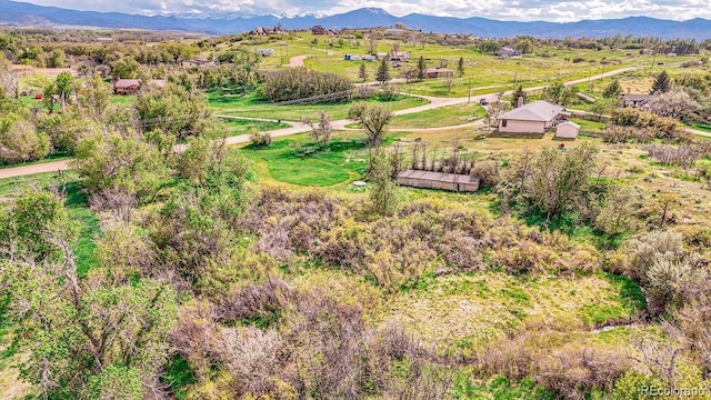 birds eye view of property with a mountain view and a rural view