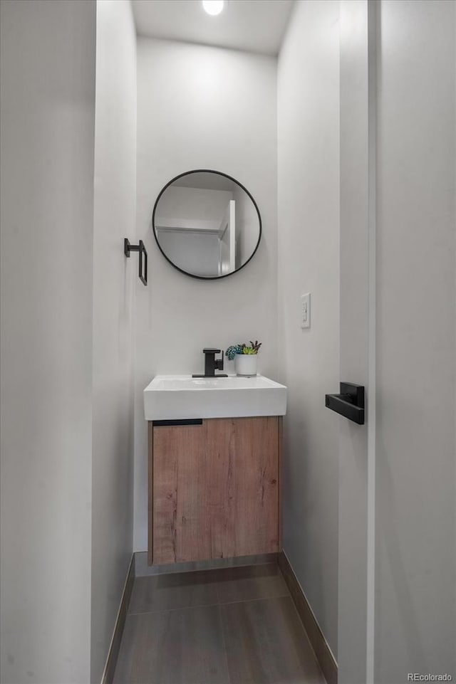 bathroom with hardwood / wood-style floors and vanity