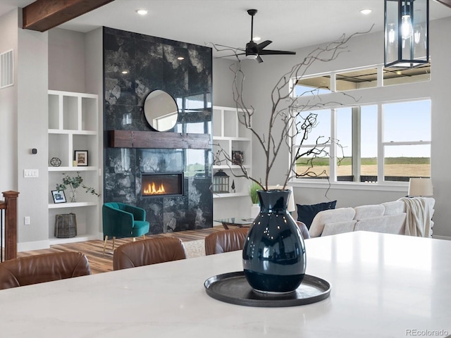 62101 E 32nd Ct, Strasburg, CO 80136 - dining area with a premium fireplace, a ceiling fan, built in features, and recessed lighting