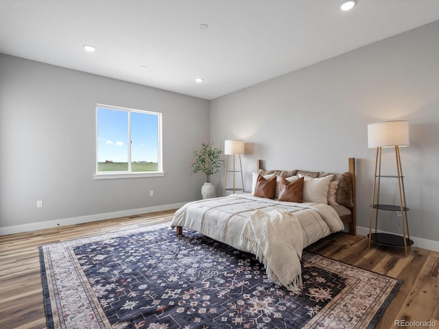 62101 E 32nd Ct, Strasburg, CO 80136 - bedroom with wood finished floors, baseboards, and recessed lighting