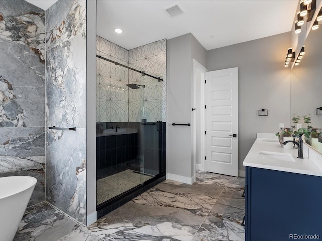 62101 E 32nd Ct, Strasburg, CO 80136 - bathroom featuring double vanity, a stall shower, marble tiled flooring, a freestanding bath, and recessed lighting