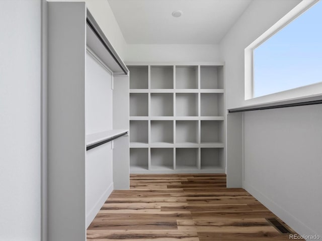 62101 E 32nd Ct, Strasburg, CO 80136 - walk in closet featuring wood finished floors