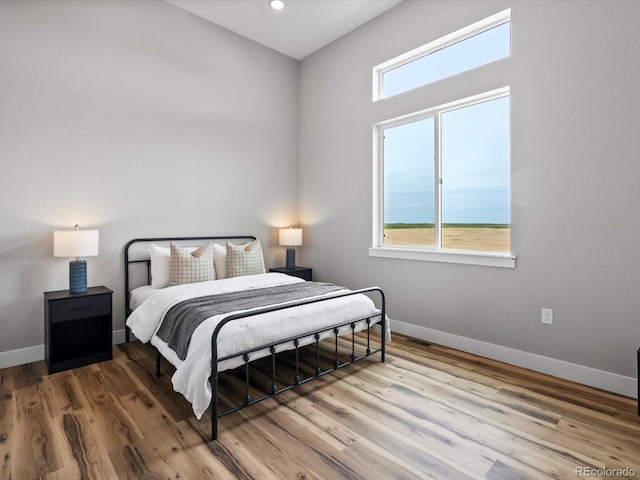 62101 E 32nd Ct, Strasburg, CO 80136 - bedroom featuring baseboards, wood finished floors, and recessed lighting
