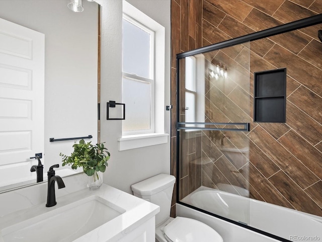 62101 E 32nd Ct, Strasburg, CO 80136 - full bathroom featuring vanity, shower / bath combination with glass door, and toilet