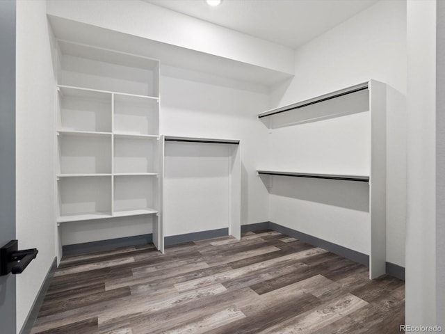 62101 E 32nd Ct, Strasburg, CO 80136 - spacious closet featuring dark wood-style flooring