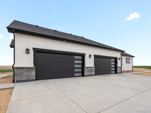 62101 E 32nd Ct, Strasburg, CO 80136 - garage featuring driveway