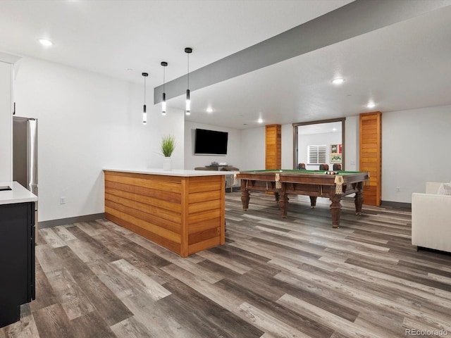62101 E 32nd Ct, Strasburg, CO 80136 - kitchen with billiards, wood finished floors, a peninsula, light countertops, and recessed lighting