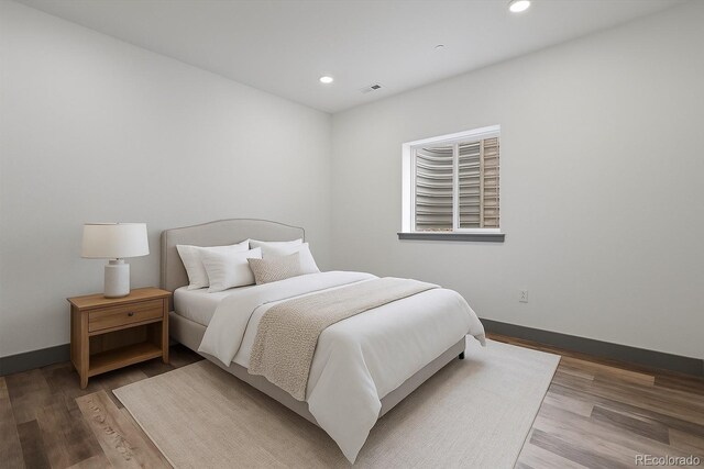 62101 E 32nd Ct, Strasburg, CO 80136 - bedroom featuring recessed lighting, wood finished floors, and baseboards