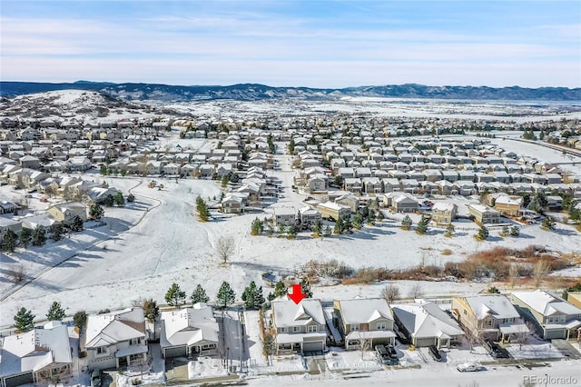 snowy aerial view with a mountain view