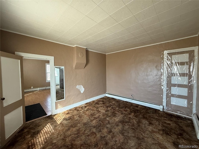 empty room with ornamental molding, a baseboard heating unit, carpet, and a baseboard radiator