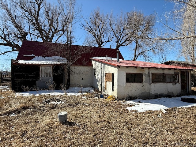 view of snowy exterior featuring stucco siding