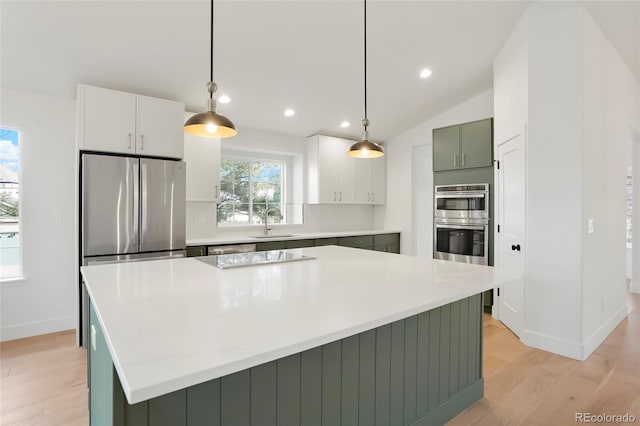 kitchen featuring pendant lighting, stainless steel appliances, and a kitchen island