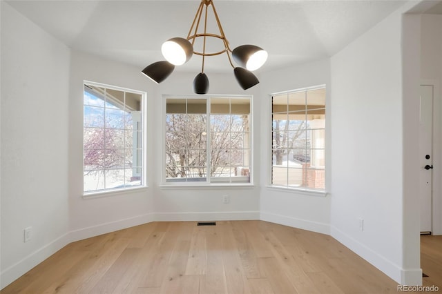 unfurnished dining area featuring plenty of natural light and light hardwood / wood-style floors