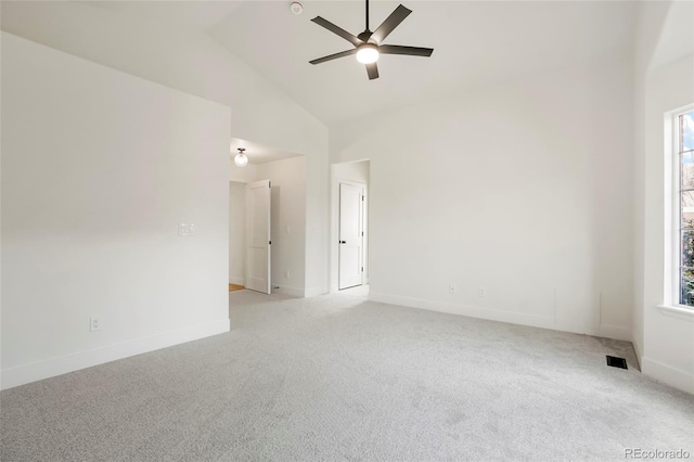 unfurnished room with light carpet, plenty of natural light, high vaulted ceiling, and ceiling fan