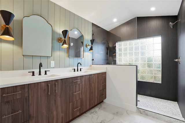 bathroom with vanity, vaulted ceiling, and walk in shower