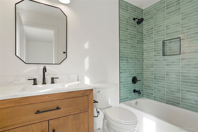 full bathroom featuring vanity, toilet, and tiled shower / bath combo